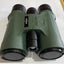 Green binoculars with a brand logo on a white background
