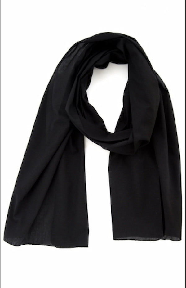 Black scarf draped over a white background