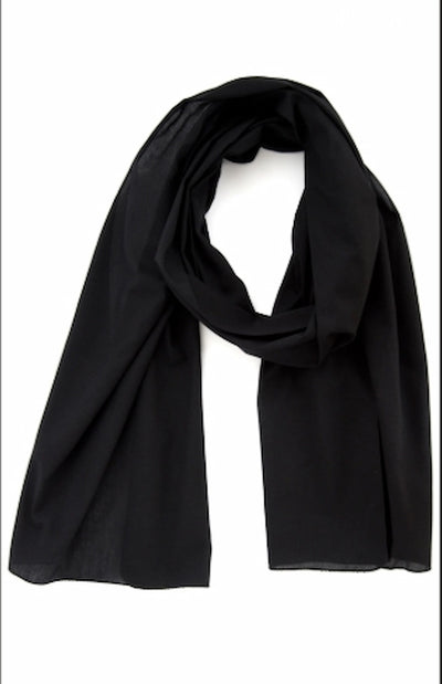 Black scarf draped over a white background