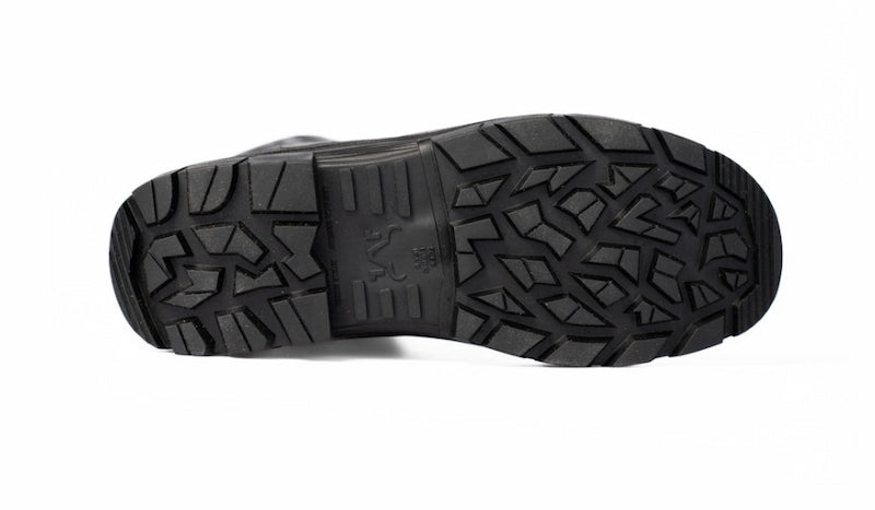A close-up, top-down view of a black rubber boot sole with deep, aggressive tread patterns, shown against a plain white background.