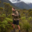 Man hiking in a mountainous forested area with a backpack