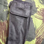 Black mesh pouch on a camouflage-patterned background