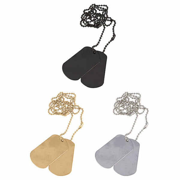 Three metallic dog tags on chains against a white background