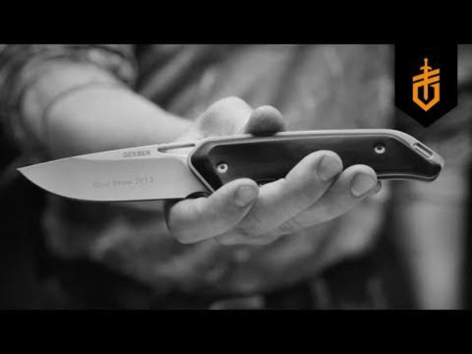 Hand holding a Gerber knife with a blurred background