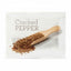 Packaged cracked pepper with a wooden scoop on a white background