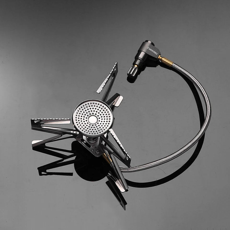 Portable camping stove with hose on a gray background