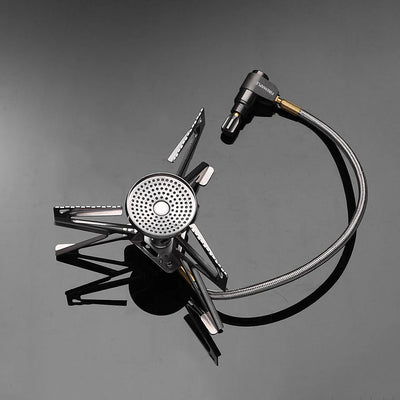 Portable camping stove with hose on a gray background
