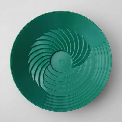 Green plastic lid with a textured surface on a white background