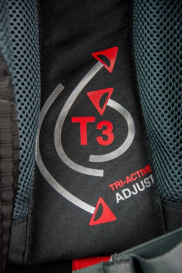 Close-up of a backpack with 'T3' and 'Tri-Active Adjust' branding on a black background.