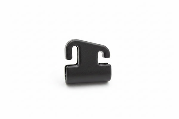 A small black plastic clip or hook-shaped fastener component, photographed on a clean white background.