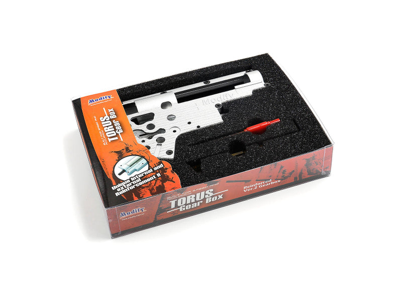 The product image shows a Torus Reinforced Gearbox 8mm - Version 2 Gearbox placed inside its packaging, which has foam protection. The gearbox is white, and the packaging has a black interior and an orange exterior with branding and product information.