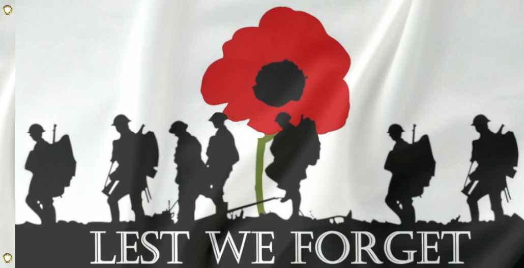 A flag with a white background featuring silhouettes of soldiers and a large poppy in the center with the text 'LEST WE FORGET' across the bottom.